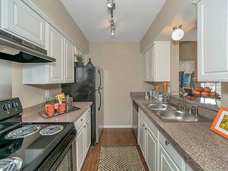 Modern kitchen with range, refrigerator, and dishwasher