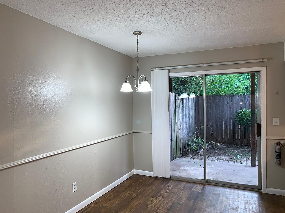 Open dining room off of kitchen and living room leading to back patio.