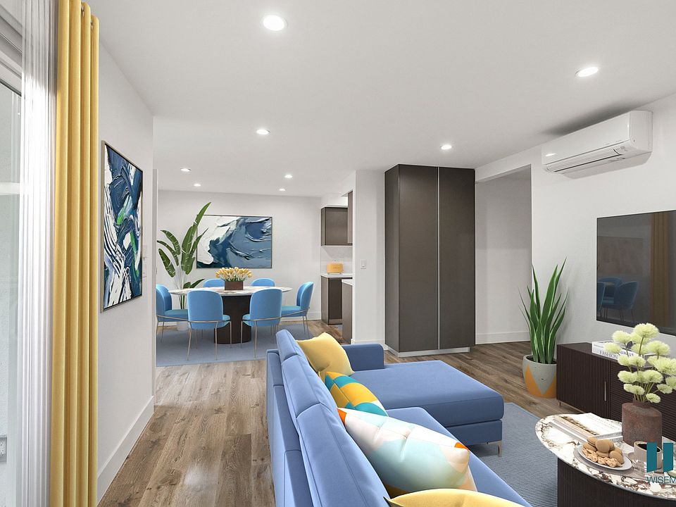 Open-Concept Dining and Living Room with Storage Cabinet and Patio
