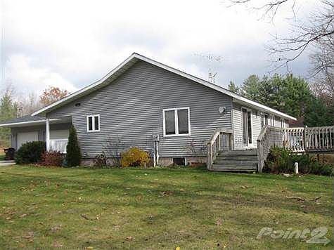 View of the west side of the house from done by the lake shore.