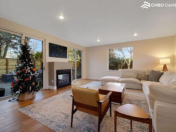 Family room with indoor/outdoor fireplace and RH couch