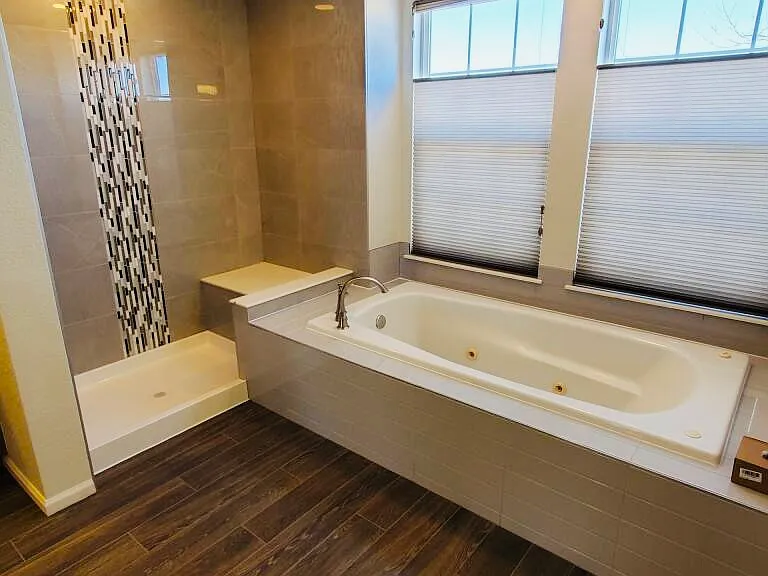 Updated master bathroom with shower and bathtub.