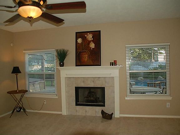 Large Family Room / Den with Gas Log Fire Place, New Carpet, New Paint, Wired for Surround Sound and Large Windows looking out into back yard & pool.