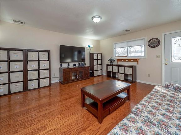 Radiant sunlight floods the home and glistens on the hardwood floors throughout the main living area.