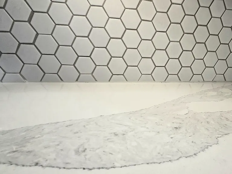 Close up of the kitchen white quartz and backsplash