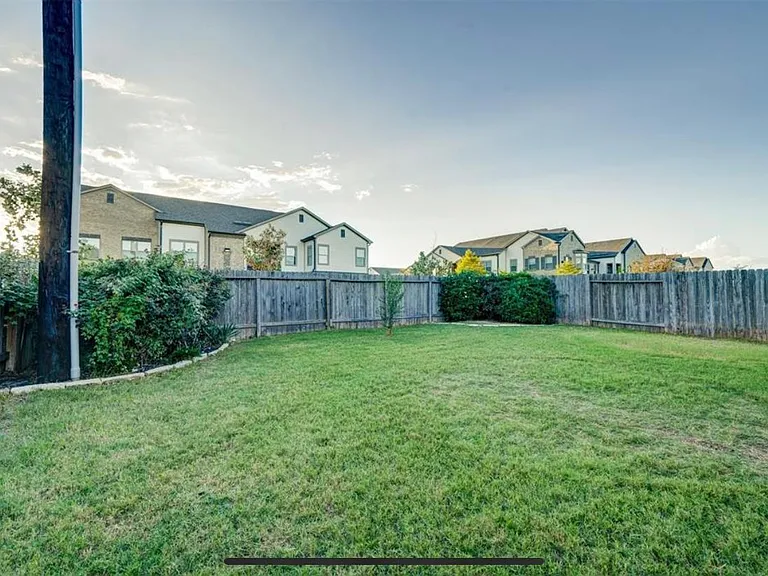 Back yard is nicely landscaped and has plenty of room for play