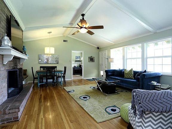 This home packs a lot of wow factor! Main combo living/dining area with vaulted ceiling, bank of win