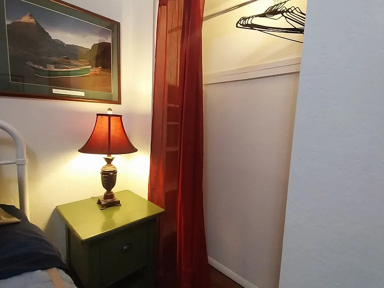 One of two bedroom closets, bedside tables and lamps next to new queen mattress