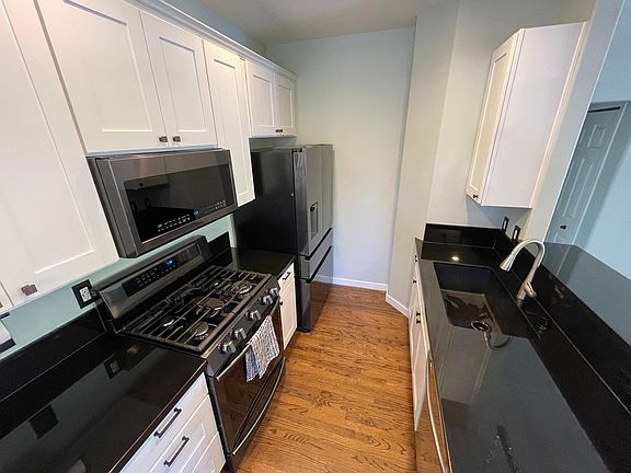 completely updated kitchen with new cabinets, black granite, and appliances