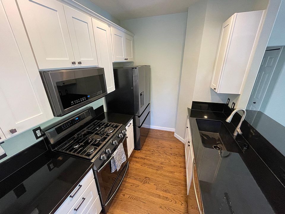 completely updated kitchen with new cabinets, black granite, and appliances
