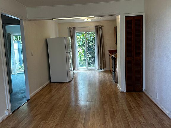 Living room and kitchen lead to sliding doors for lanai
