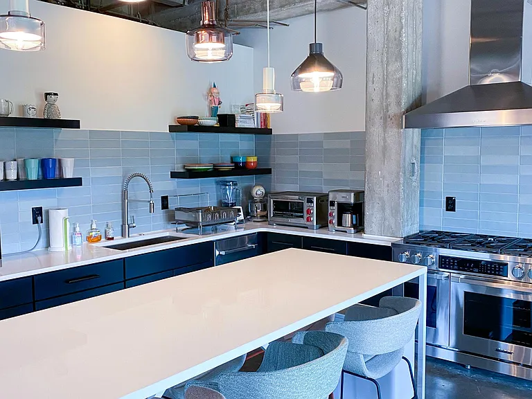 New kitchen with open shelving and quartz counters.