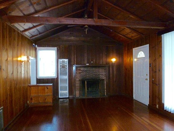 Living room has wood-burning fireplace