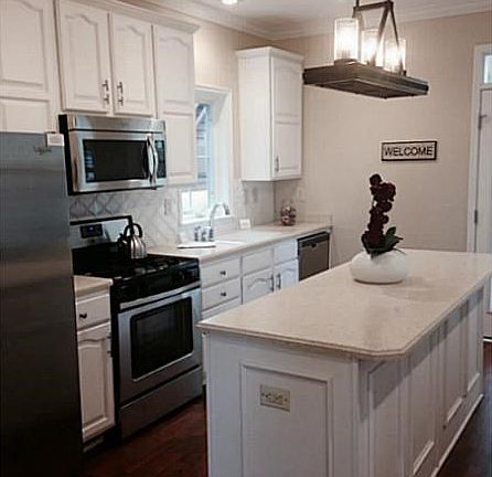 Kitchen. SS appliances, Corian counters, Designer lighting make cooking a pleasure