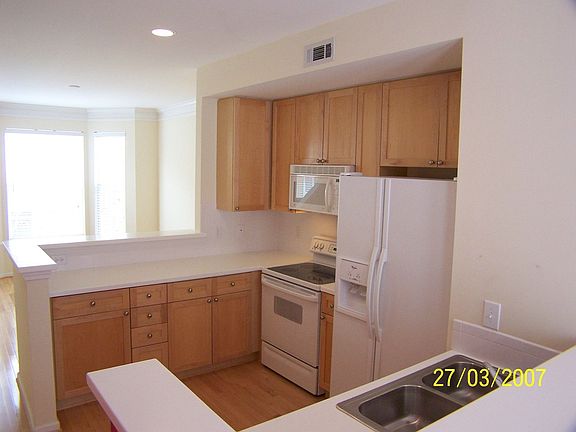 Spacious Open Floor Plan Kitchen with Maple Cabinets, Hardwood floors, Corian