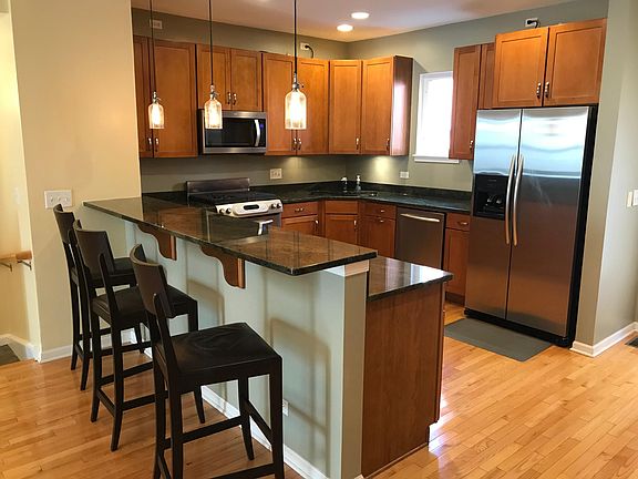 Kitchen features stainless steel appliances, granite countertops and breakfast bar