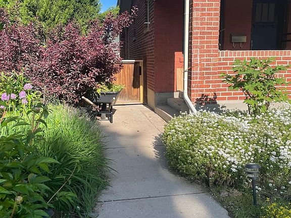Gate on side of house, leads to the backyard and private entrance to garden unit