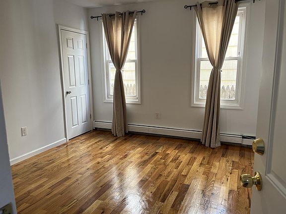 Living room but currently furnished with a couch and side chair