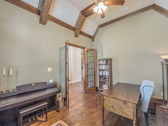 View from the front door. The wood floors just keep going!  The ceiling of the two story foyer is nearly 20' high giving a feeling of grandeur. The study is on the right.