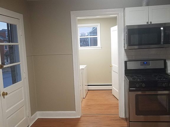Kitchen with view of the laundry room and entrance door which leads to the covered porch