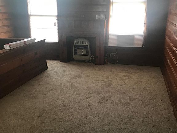 New carpet throughout. Living room with fireplace