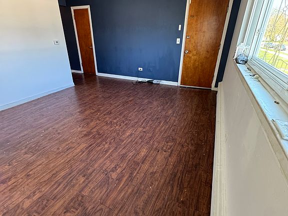 Spacious living/ dinning room with accent walls and hardwood floor plus TWO closets