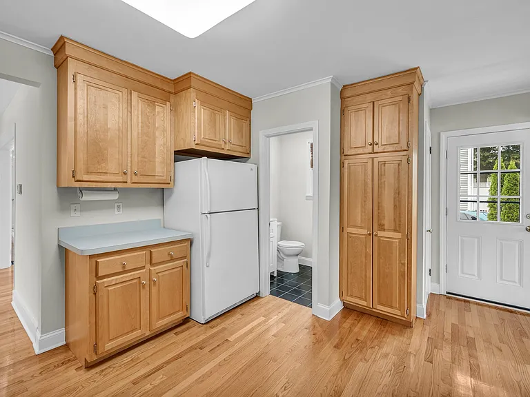 View in kitchen to half bath and side entry door.