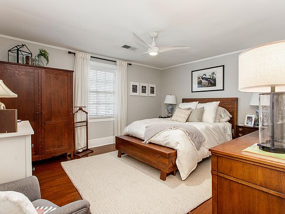 Master bedroom with amazing light ceiling fan and ample room.