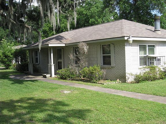 SIDE VIEW FROM DRIVEWAY SHOWING SIDEWALK OF HOME