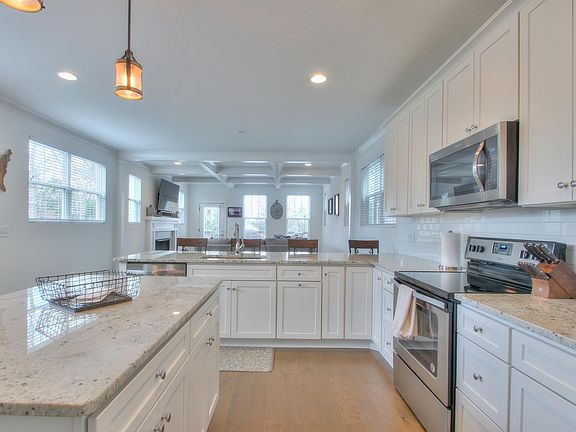 Open kitchen/living room concept with room for kitchen table between couch and the 4 barstools.