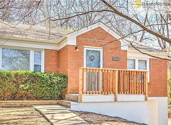 Fresh exterior paint, newly painted door and new handrail compliment brick exterior.