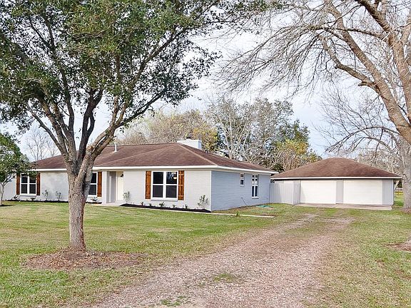 This property has a spacious front yard, mature trees and an oversized garage!