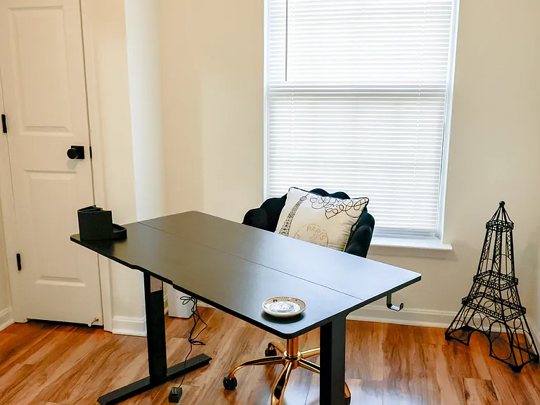 Versatile room ideal for a home office, study, or additional bedroom_featuring beautiful hardwood flooring and abundant natural light.