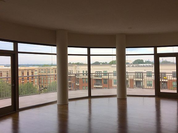 Open concept living area with large crescent shaped terrace.