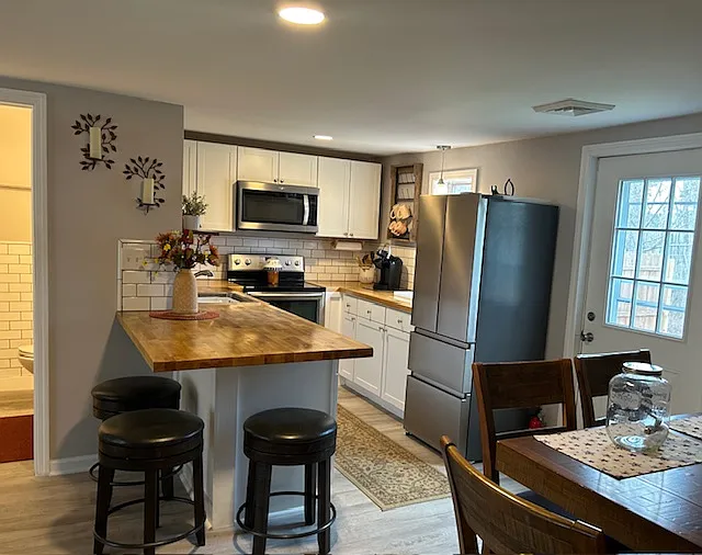 View from bedroom, dining room bartop and access to backyard space with privacy fence.