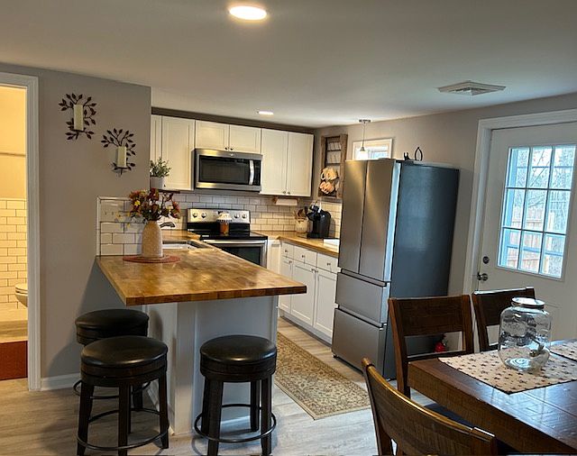 View from bedroom, dining room bartop and access to backyard space with privacy fence.