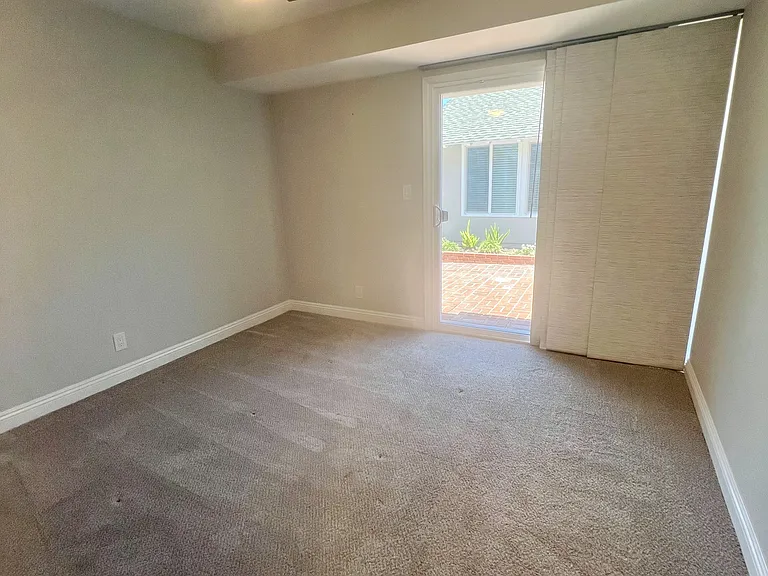 Bedroom #4 with sliding glass door to entry patio