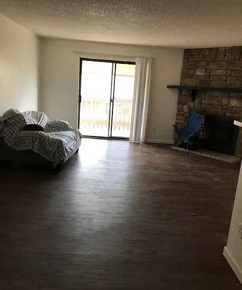 Big size living room with a fireplace and access to a big balcony