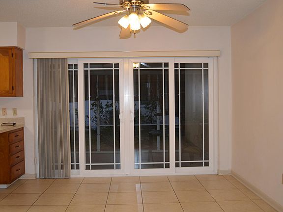 Dining room without furniture sliding doors to screened porch.