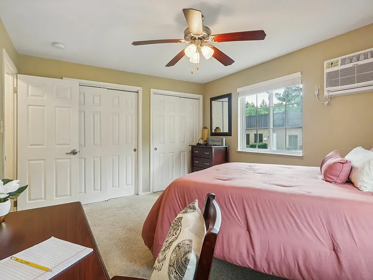 Enjoy a bright and spacious bedroom with ample storage at University Oaks Apartments near Kent State University.