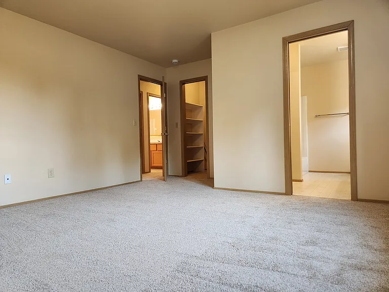 Primary bedroom - walk in closet to the left, primary bath to the right