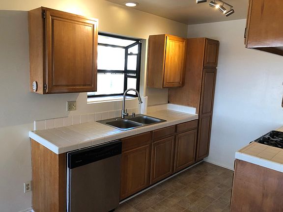 sink area with dishwasher and garden window