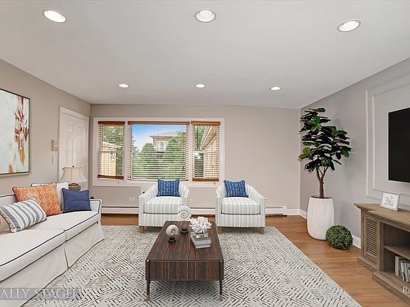 Living Room with views of the courtyard. Stunning Hardwood flooring throughout! Recessed Lighting. F