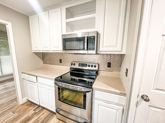 Kitchen area with flat top stove.