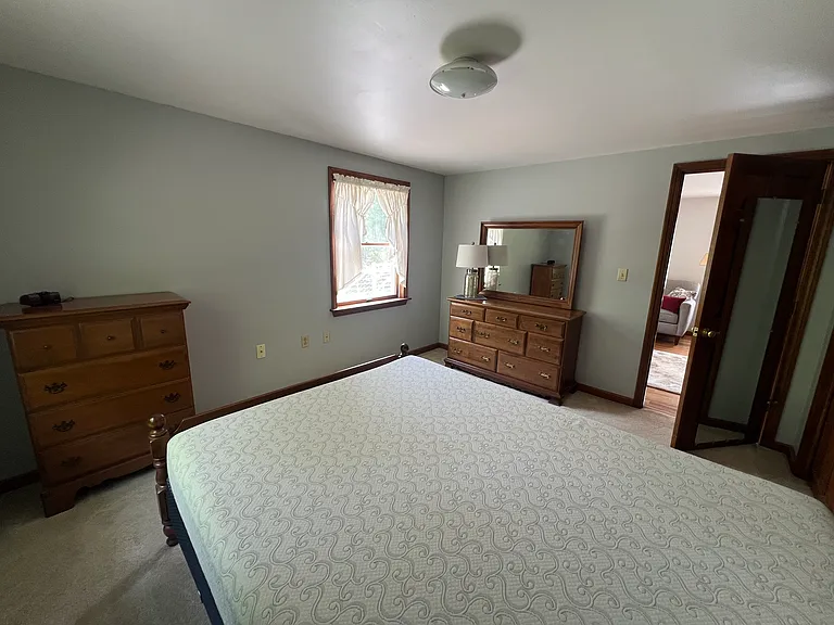 1st bedroom with queen sized bed and two dressers