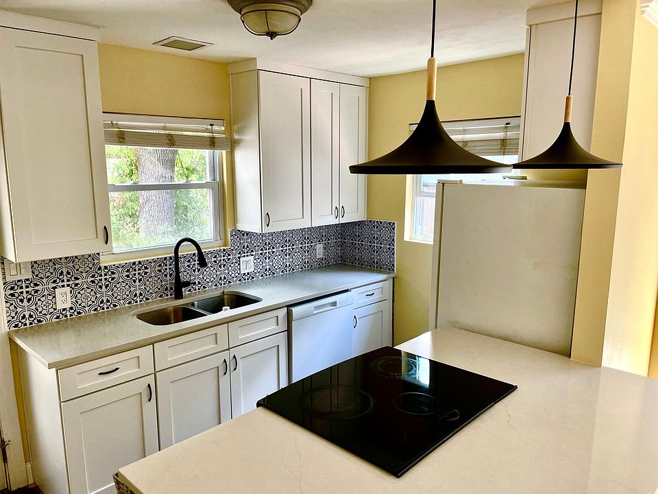 Brand new kitchen with quartz counters and Spanish tile backsplash