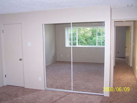 Second bedroom with private rear facing balcony.
