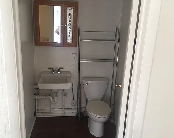 Bathroom, storage above the sink and above the toilet. Everything in the unit has been completely painted and professionally cleaned.