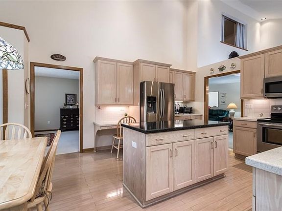 The over-sized kitchen is so naturally bright - vaulted ceiling with skylights, countless cabinets and great storage.