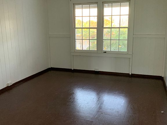 Living room has large windows that let in lots of light.